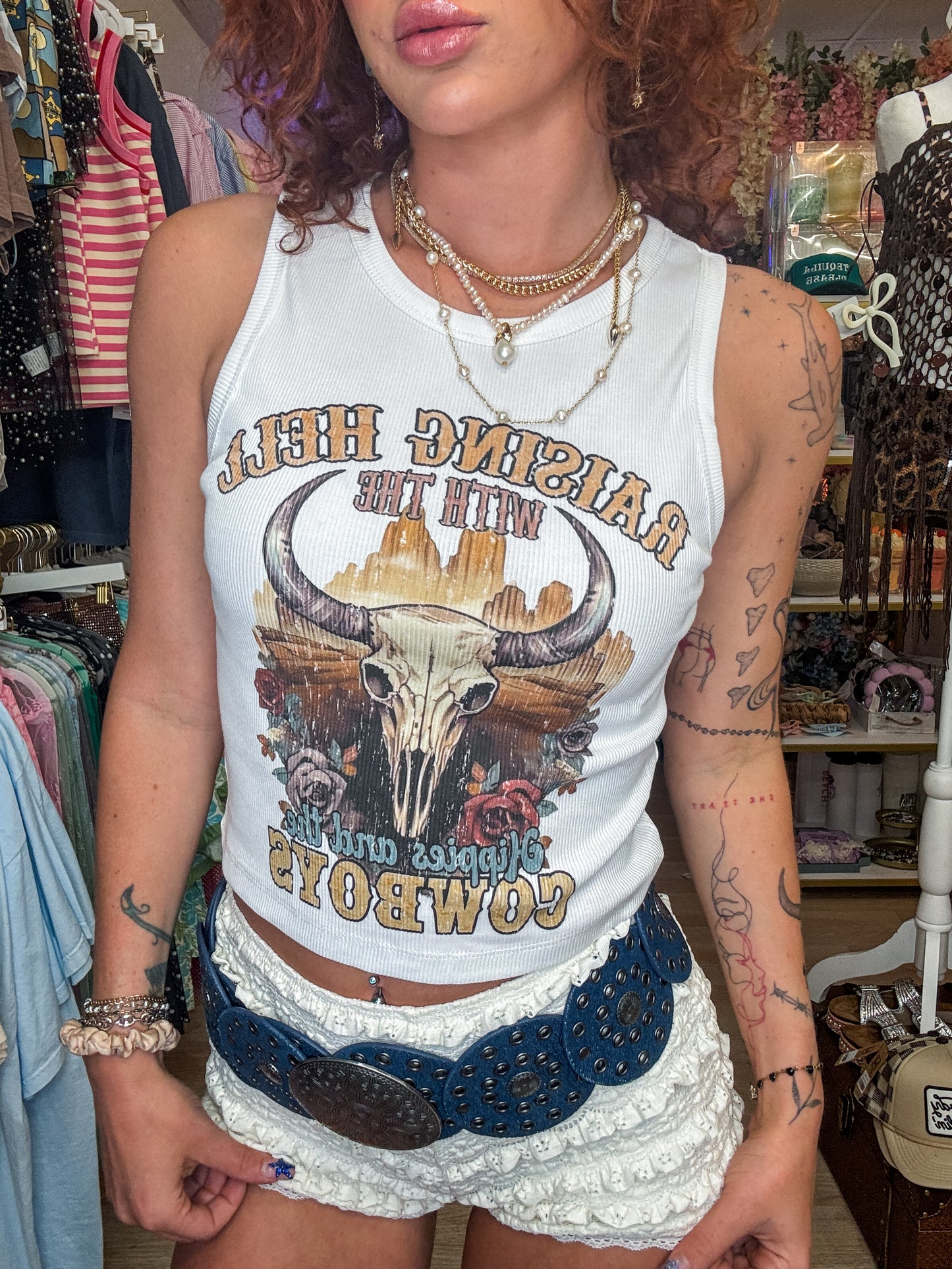 Raisin He’ll with the hippies and the Cowboys tank